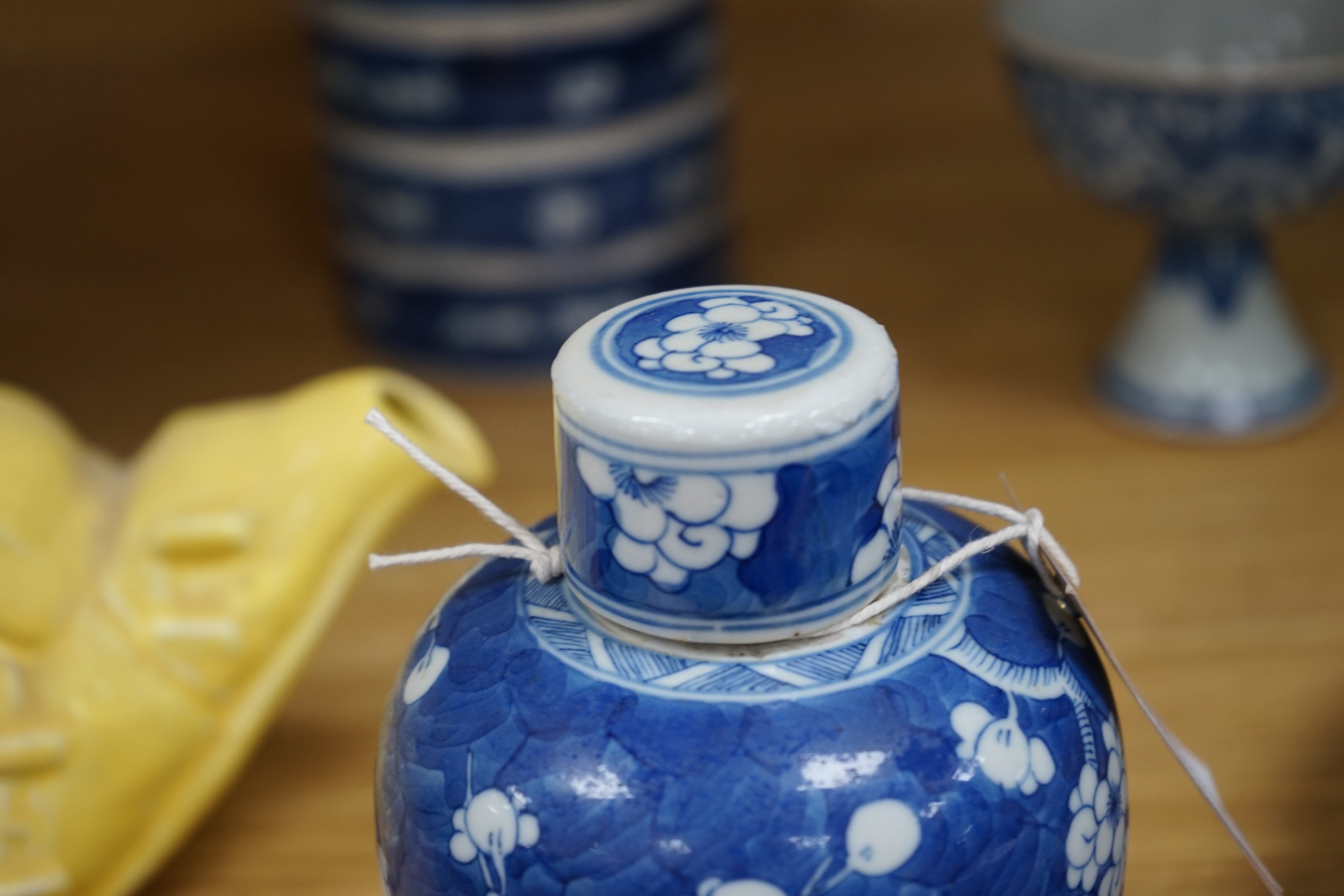 A Chinese blue and white ovoid jar and cover and similar stacking box, Kangxi and a Qing blue and white footed cup, tallest 15cm